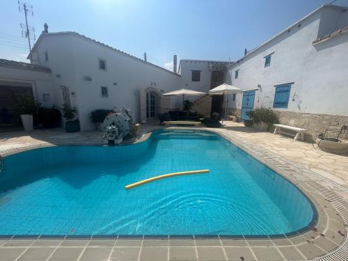 a swimming pool in the courtyard of a building at Little Stone House in Lymbia
