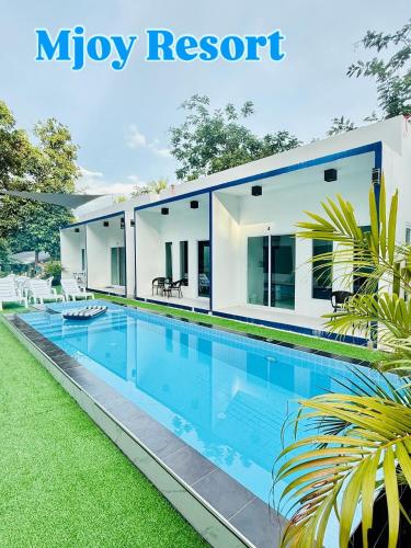 a house with a swimming pool in the yard at MJOY Resort in Taling Ngam Beach