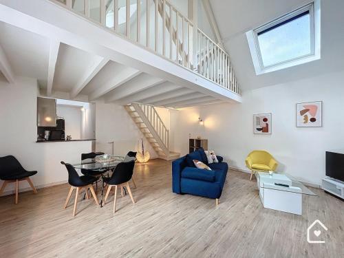 a living room with a blue couch and a table at La Loggia - Premium apartment 60 m2 in Châtellerault