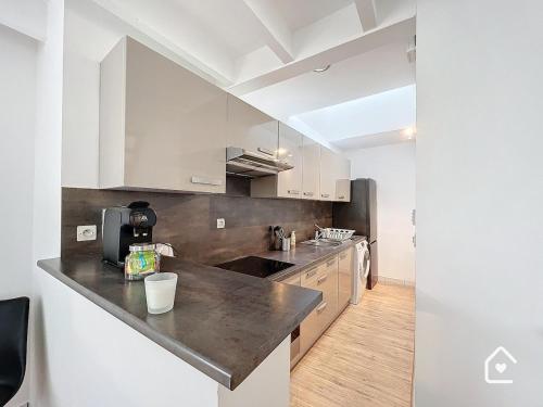a kitchen with white cabinets and a counter top at La Loggia - Premium apartment 60 m2 in Châtellerault