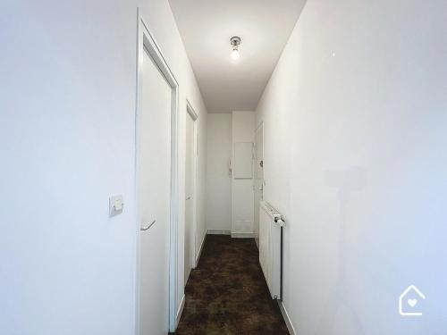 a hallway with a white wall and a door at La Loggia - Premium apartment 60 m2 in Châtellerault