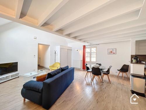 a living room with a blue couch and a table at La Loggia - Premium apartment 60 m2 in Châtellerault
