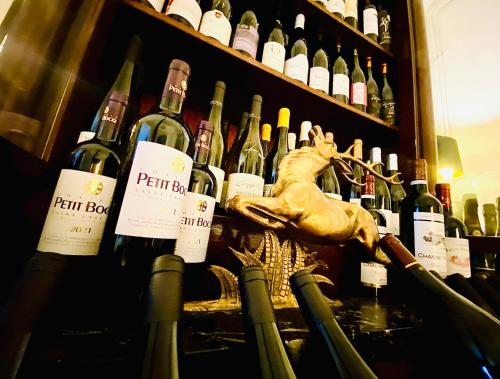 a bunch of bottles of wine on a shelf at Hôtel VCB Ciney Centre-ville in Ciney