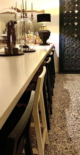 a long table with a row of chairs and a lamp at Hôtel VCB Ciney Centre-ville in Ciney