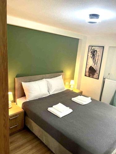 a bedroom with a bed with two towels on it at Nostos in Nea Moudania
