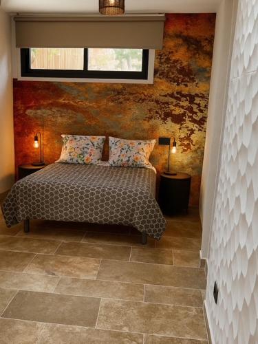 a bedroom with a bed with two lamps and a window at Azulik Corsica in Corbara