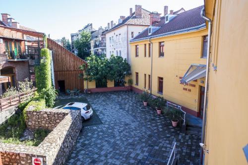 a view of a street with a car in a courtyard at Boutique Hotel Sopianae in Pécs