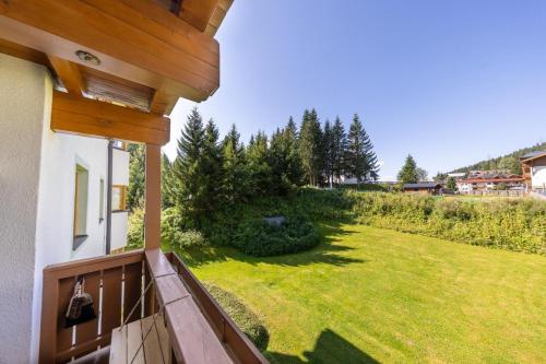a view from the balcony of a house with a yard at Haus Mees in Königsleiten