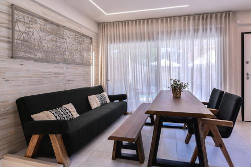 a living room with a couch and a table at September15 Suites- Meganisi in Meganisi