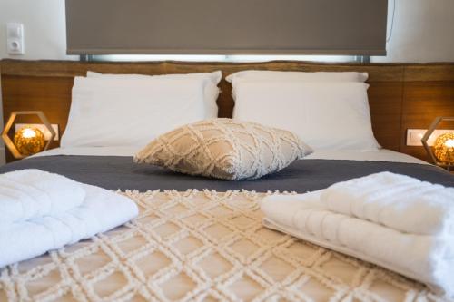 a bed with two pillows on top of it at September15 Suites- Meganisi in Meganisi