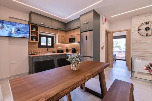 a kitchen with a wooden table with flowers on it at September15 Suites- Meganisi in Meganisi