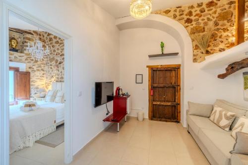 a living room with a bed and a couch at Casa Rural Lliber in Lliber