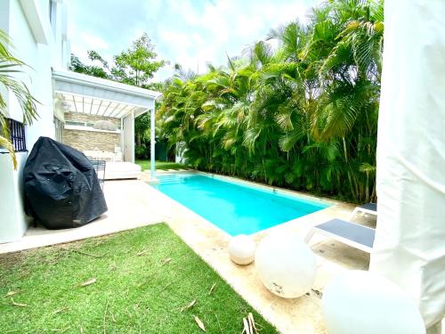 a swimming pool in the backyard of a house at Luxury Villa Pool and BBQ in San Juan Lakes Los Colales RD in Punta Cana