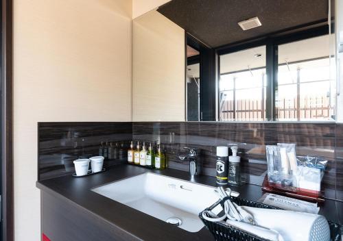a bathroom with a sink and a mirror at LiVEMAX RESORT Atami OCEAN in Atami
