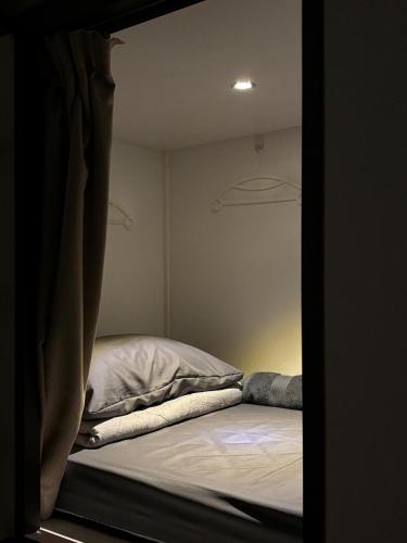 a bed in a small room with a window at Kek Lok Si Inn in Ayer Itam