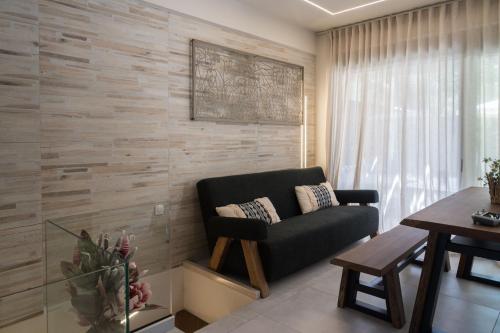 a living room with a couch and a table at September15 Suites- Meganisi in Meganisi