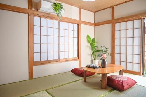 a room with a table and some windows at Asakusa Ginza direct access to the airport in Tokyo
