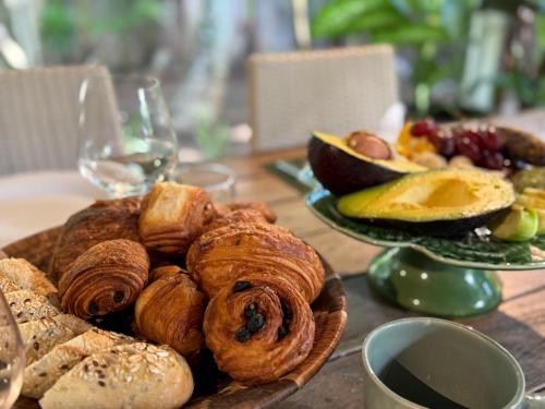 a plate of pastries and bread on a table at Waka Lodge - House with garden in Blue Bay