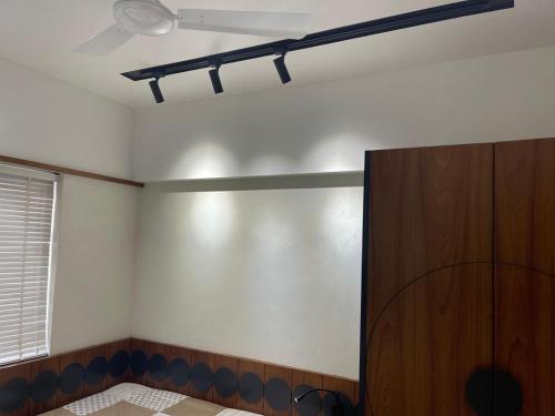 a room with a ceiling fan and a closet at Tranquil Loft Escape in Pune