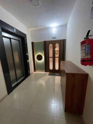 a hallway with a wooden table and a door at Tranquil Loft Escape in Pune