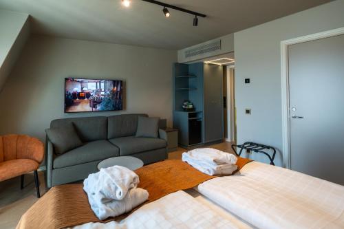 a living room with two beds and a couch at Scandic Arvika in Arvika