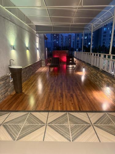 a room with a hard wood floor in a building at Tranquil Loft Escape in Pune