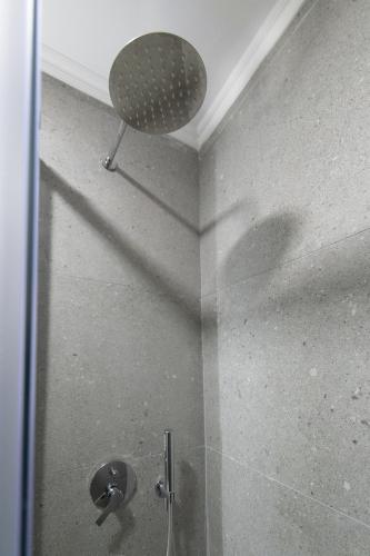 a shower with a glass door with a shower head at September15 Suites- Meganisi in Meganisi