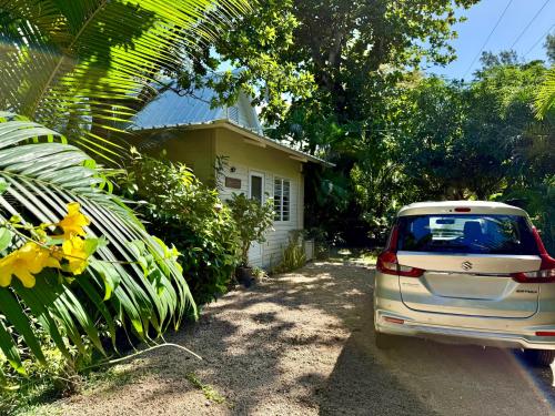 a car parked in front of a house at Waka Lodge - House with garden in Blue Bay