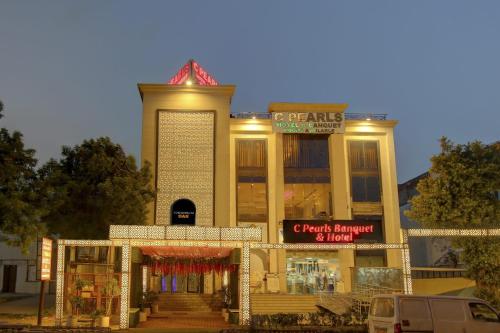a store front of a building with lights on at Super Townhouse Oak Hotel C Pearls in New Delhi