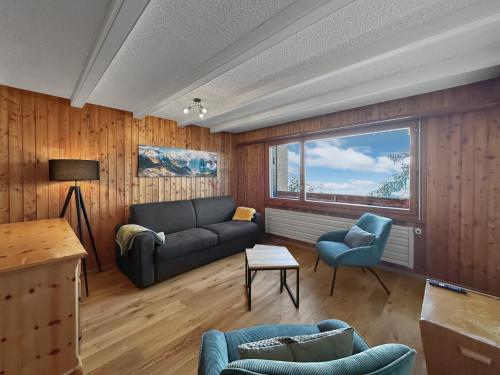 a living room with a couch and two chairs at Ultimate Condo - 4 Valleys - Ski-in out - Swiss Alps in Vex