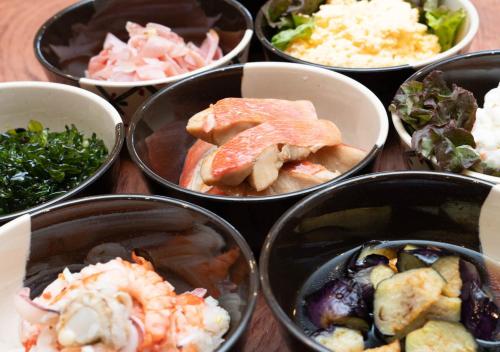 a group of bowls filled with different types of food at LiVEMAX RESORT Atami OCEAN in Atami