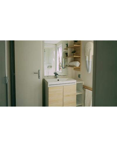 a bathroom with a sink and a mirror at Camping Santa Elena in Lloret de Mar