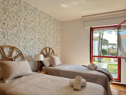 a bedroom with two beds and a window at Apartamento El Sureste 6824 in Noja