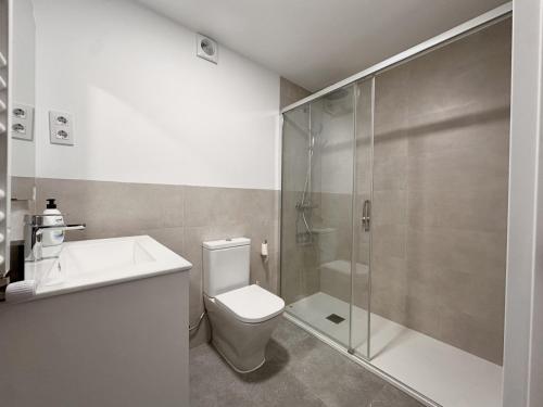 a bathroom with a shower and a toilet and a sink at Apartamento El Sureste 6824 in Noja