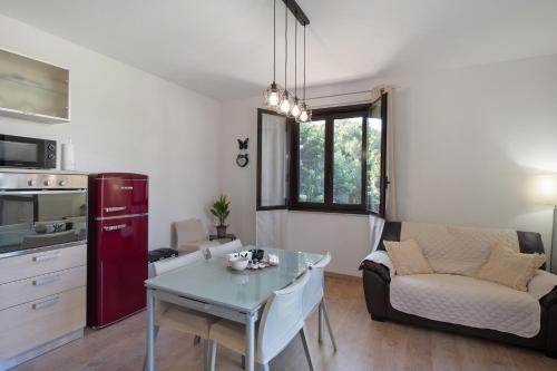 a kitchen and living room with a table and a couch at Tra Monti E Mare in Cisano sul Neva