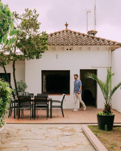 a man walking in front of a house at Camping Santa Elena in Lloret de Mar