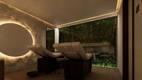a salon with two massage chairs and a mirror at Novotel Malta Sliema in Il-Gżira