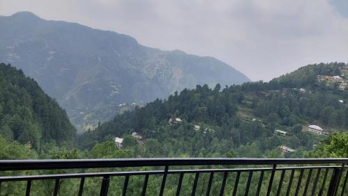 a view of a mountain with trees and houses at HK Heights - Sunset Valley Retreat in Nathia Gali