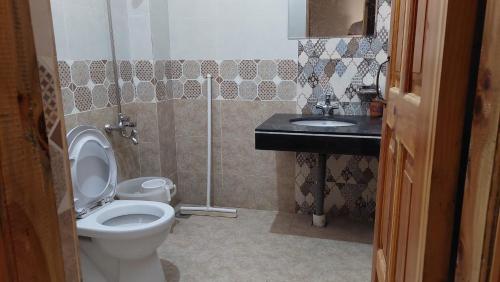 a bathroom with a toilet and a sink at HK Heights - Sunset Valley Retreat in Nathia Gali