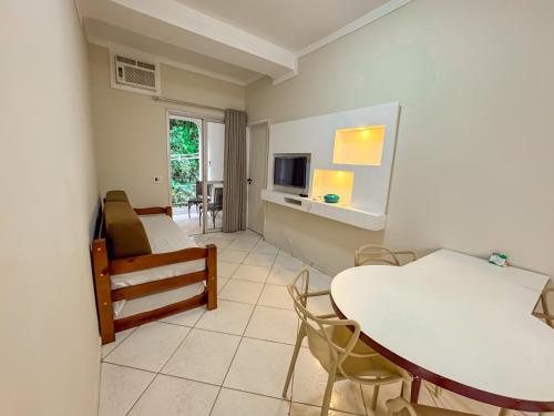 a living room with a table and a couch at Hotel Nacional Inn Guarujá in Guarujá