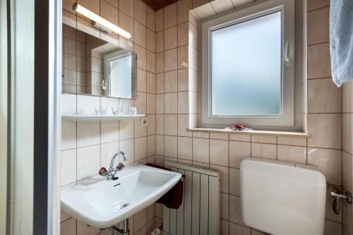 a bathroom with a sink and a mirror at Haus Sonne in Kirchdorf in Tirol