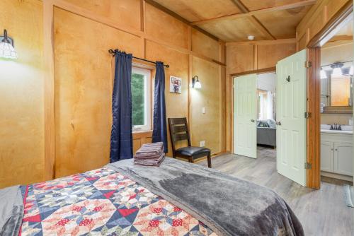 a bedroom with a bed and a chair in a room at Frog Hollow at Hocking Vacations in Logan