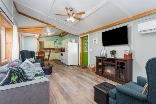 a living room with a couch and a tv and a fireplace at Frog Hollow at Hocking Vacations in Logan