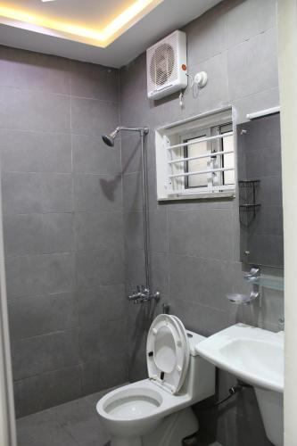 a bathroom with a toilet and a sink at Islamabad Elite Suites in Islamabad