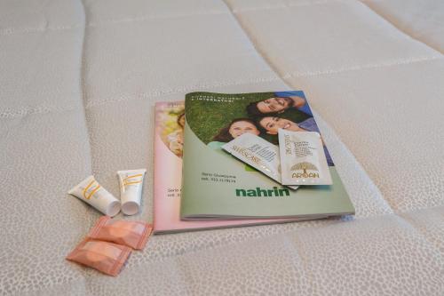 a book sitting on a bed next to a tube of toothpaste at Camera Meridiana in Roncone