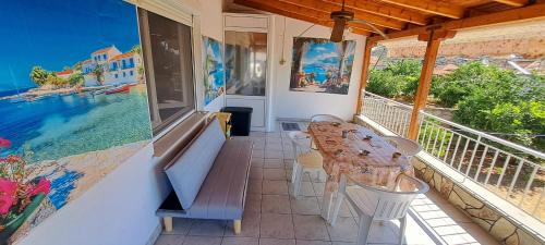 a balcony with a table and chairs and a view of the water at SUN and Sea HOUSE Kavala ammolofoi αμμόλοφοι in Eleftheres