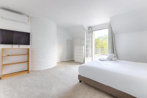 En eller flere senge i et værelse på Villa Kiwi à 10 min de Disneyland Paris