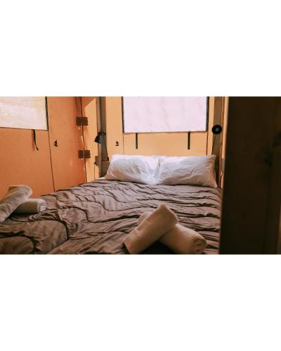 a bedroom with two legs laying on a bed at Camping Santa Elena in Lloret de Mar