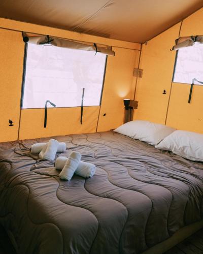 a large bed in a room with a large window at Camping Santa Elena in Lloret de Mar