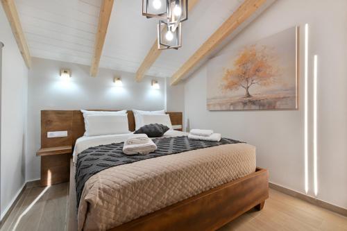 a bedroom with a bed with a cat laying on it at September15 Suites- Meganisi in Meganisi